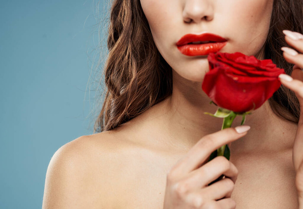 Romantic woman with red rose bared shoulders and blue background brunette - Valokuva, kuva