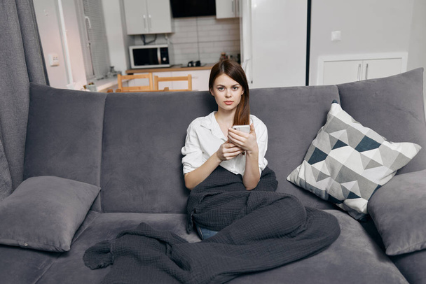 women on sofa with mobile phone and gray plaid comfort front view - Fotó, kép