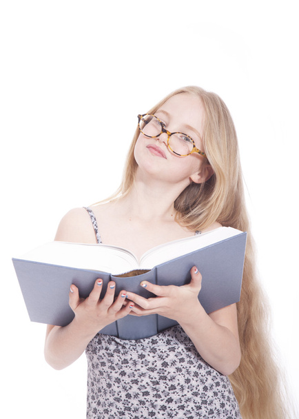 young blond girl with glasses and large book in studio - Photo, Image