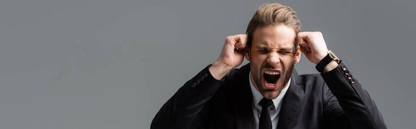 aggressive businessman shouting with clenched fists isolated on grey, banner - Photo, Image