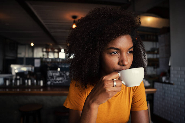 Ethnic female sipping hot coffee relaxing in rustic restaurant  - Photo, Image