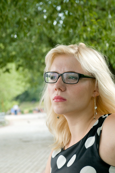 The thoughtful portrait of a beautiful girl in glasses - Fotó, kép