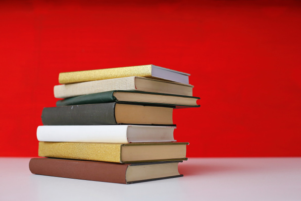Stack of books on red background - Photo, Image