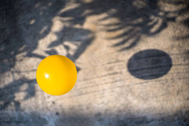 yellow ball and bouncing shadow - Photo, Image