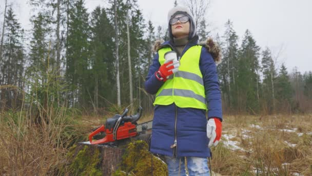 Woman worker with cup of take away coffee in forest - Footage, Video