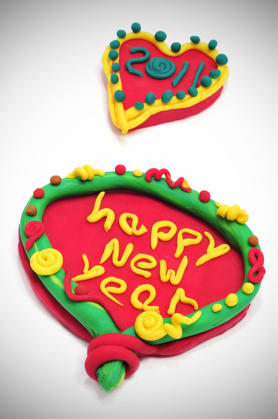 Happy new year 2011 in a design made with modelling clay on a white background - Photo, Image