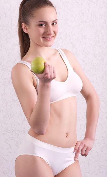 Young woman with green apple - Foto, afbeelding