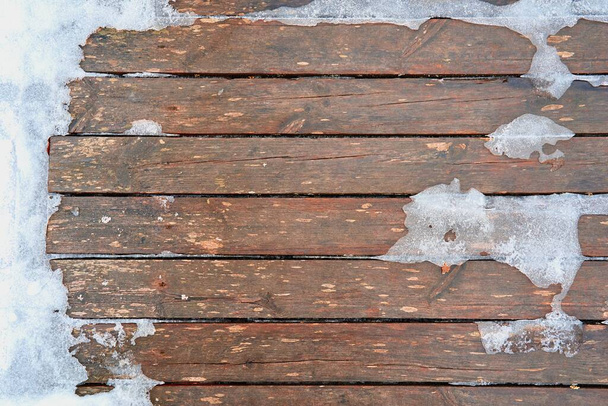 abstract texture of wooden boards for background with surface partially covered with ice and snow - Photo, Image