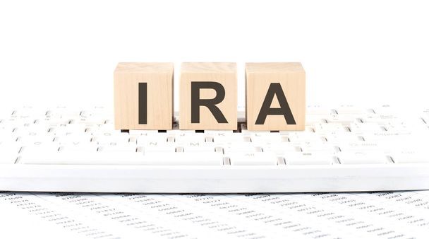 IRA -word wooden block on the keyboard background witn chart - Photo, Image