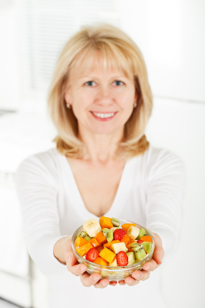 Mature Woman with fruit salad in hand. - Photo, Image