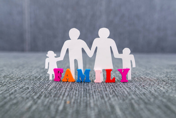 Bir ailenin silueti ve "aile" kelimesi renkli harflerle doludur.. - Fotoğraf, Görsel