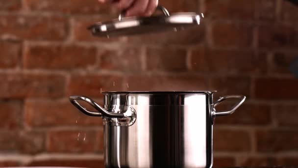 Chef picks up the Lid from the Pan. White Clouds of steam rise from under the raised cap. - Footage, Video