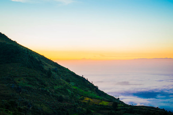 пейзаж восхода солнца с облаками и скалами в горах - Фото, изображение