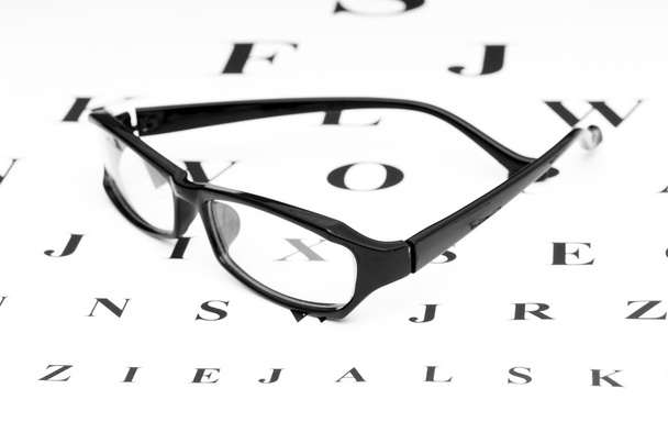 Optical reading glasses on the eyesight table - Photo, Image
