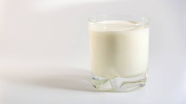 Glass of plant organic milk with shadow on white background - Photo, Image