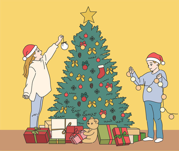 Cute boy and girl are decorating the Christmas tree. hand drawn style vector design illustrations. - Vector, Image