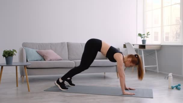 Woman Doing Transition From All-Fours To Downward Dog Pose Indoors - Footage, Video