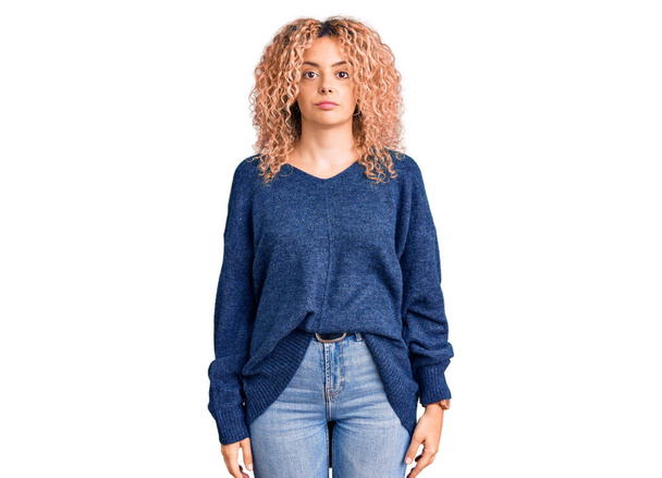 Young blonde woman with curly hair wearing casual winter sweater looking sleepy and tired, exhausted for fatigue and hangover, lazy eyes in the morning.  - Foto, immagini