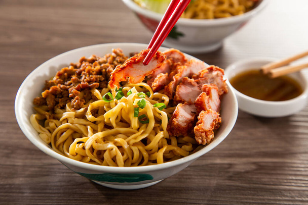 A Kolo Mee is a Sarawak Malaysian dish of dry noodles tossed in a savoury pork and shallot mixture, topped off with fragrant fried onions. - Photo, Image