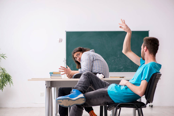 Two male pupils in bullying concept in the classroom - Photo, Image