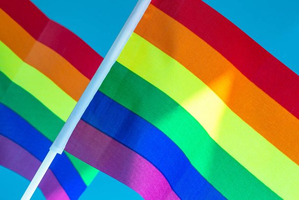 Rainbow Flag flapping in the wind, Gay Pride or LGBT Flag on blue sky background with copy space close up - Photo, Image
