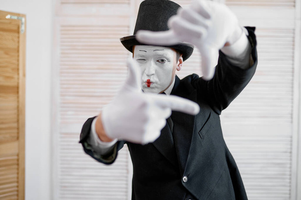 Male mime artist, photo camera gesture, photographer parody. Pantomime theater, comedian, positive emotion, humour performance, funny face mimic and grimace - Photo, Image