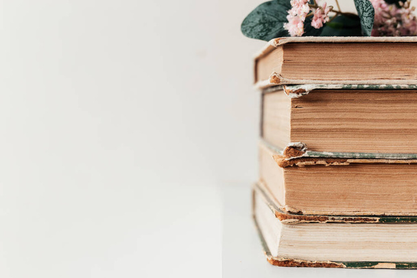 A stack of old books in the library, concept of learning, study and education, concept of science, wisdom and knowledge. High quality photo - Photo, Image