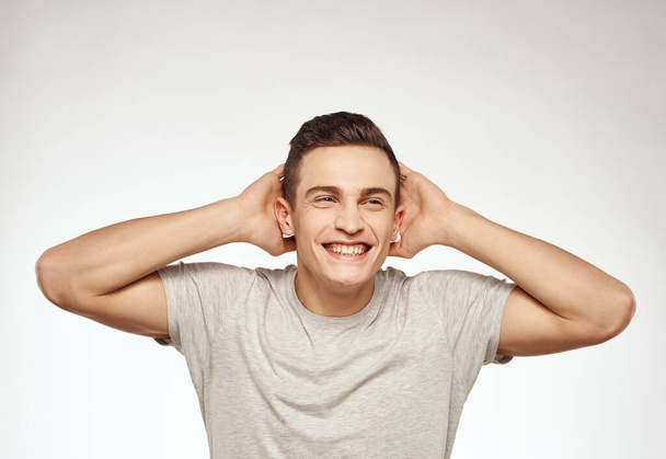 Cheerful emotional man in a T-shirt attractive appearance light background - Photo, Image