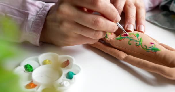 The master artist painted a handmade textile doll. Needlework. - Footage, Video