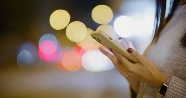 Mulher uso de telefone inteligente na rua à noite - Foto, Imagem