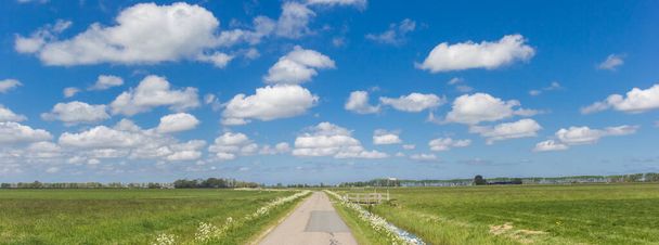 Panorama of a narrow coutry road in the dutch landscape near Groningen, Netherlands - Photo, Image