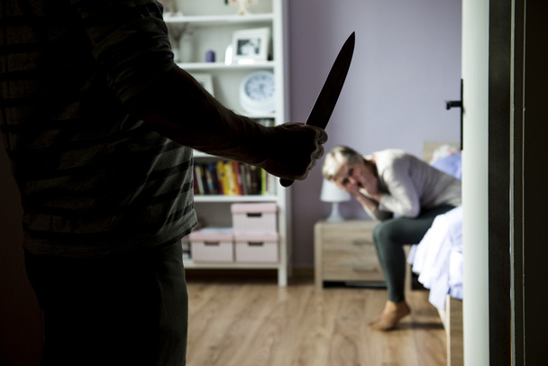 Woman scared of man with knife - Foto, afbeelding