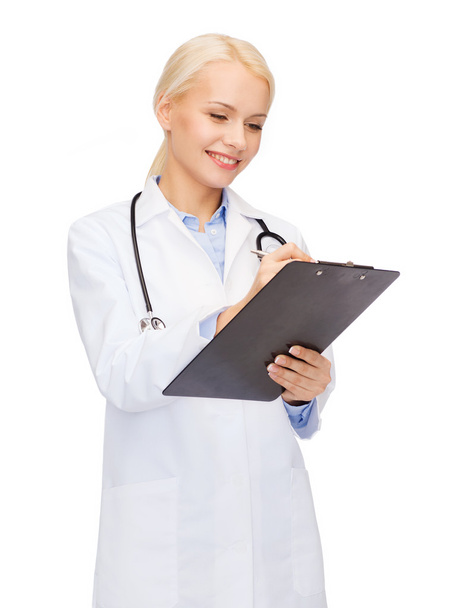 Smiling female doctor with clipboard - Valokuva, kuva