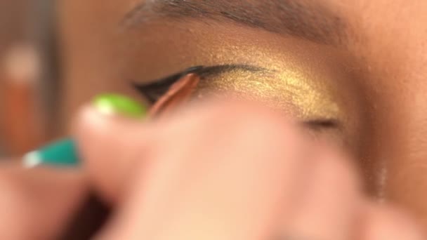 vista parcial de mujer afroamericana aplicando delineador de ojos negro - Metraje, vídeo