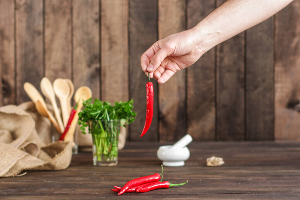 person holding red chili pepper  - Photo, Image
