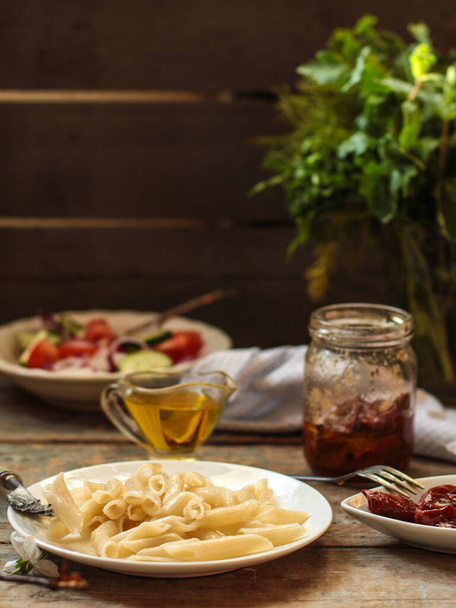 pasta with dried tomatoes and salad - Photo, Image