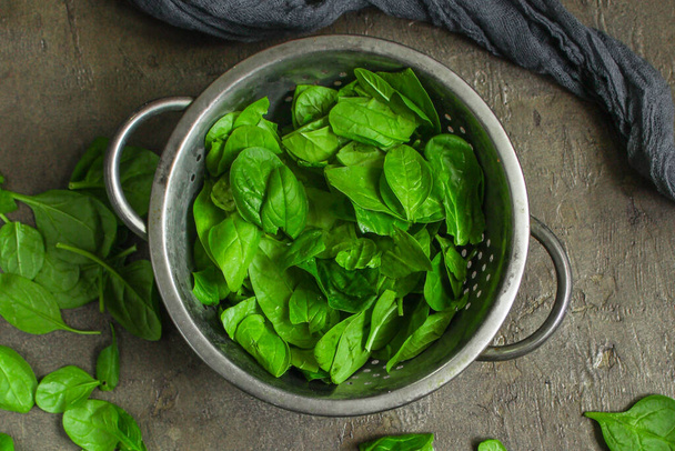 top view of fresh green spinach leaves on a gray background - Φωτογραφία, εικόνα