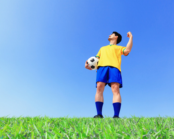 Soccer player holding ball - Foto, imagen