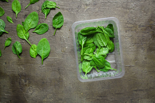 top view of fresh green spinach leaves on a gray background - Photo, image