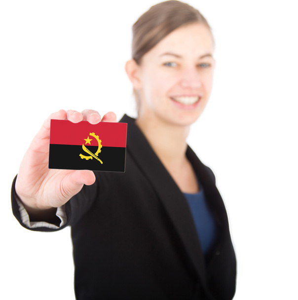 business woman holding a card with the flag of Angola - Zdjęcie, obraz