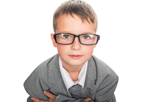 Portrait of a cute schoolboy in businessman suit and glases, isolated on white. Handsome child boy in business suit. - Foto, Imagem