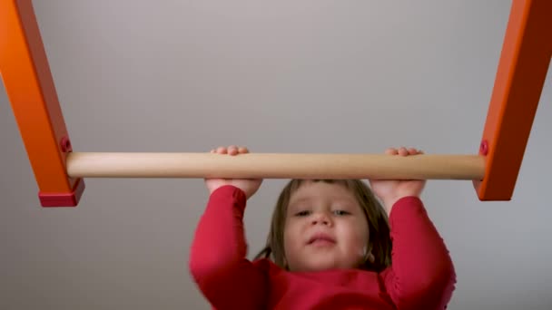 Physical development children sport education. Child workout home fit. Strong kid pull up bar exercise on gymnastic bar. Small girl exercise chin up bar workout kid on horizontal bar gym child athlete - Footage, Video