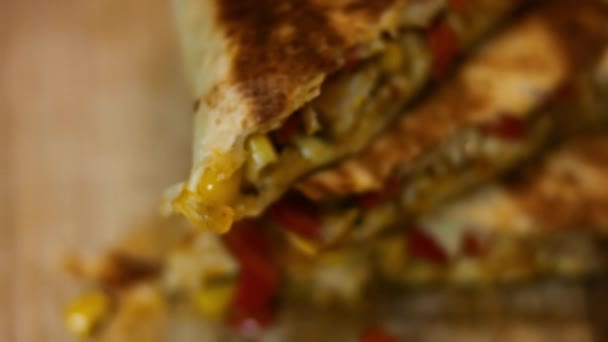Macro view of freshly fried hot chicken quesadilla on a wooden cutting board. Process of making mexican quesadillas. Slowmotion - Footage, Video