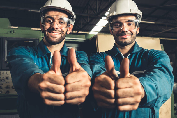Two skillful factory engineer or worker showing teamwork and partnership . - Valokuva, kuva