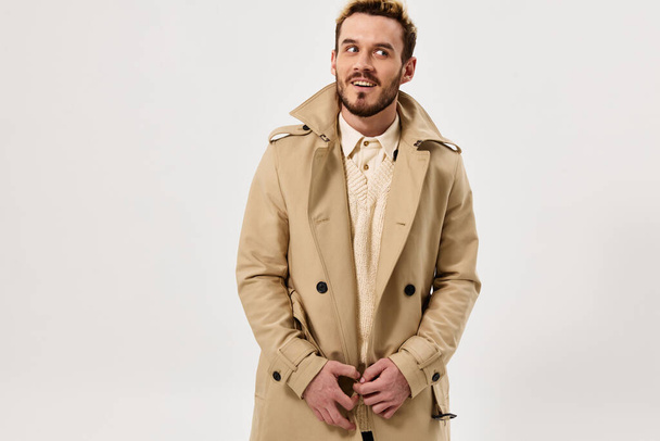 man in beige coat emotions studio modern style isolated background - Foto, immagini
