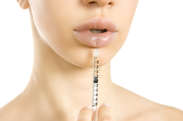 beautiful woman getting an injection in her lips. - Foto, Bild