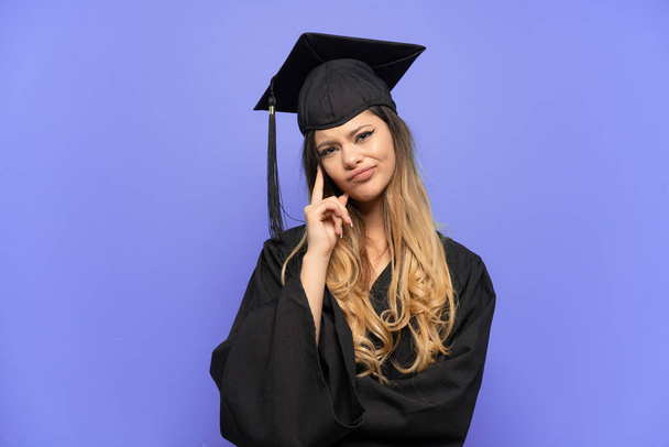 Young university graduate Russian girl isolated on white background thinking an idea - Fotografie, Obrázek