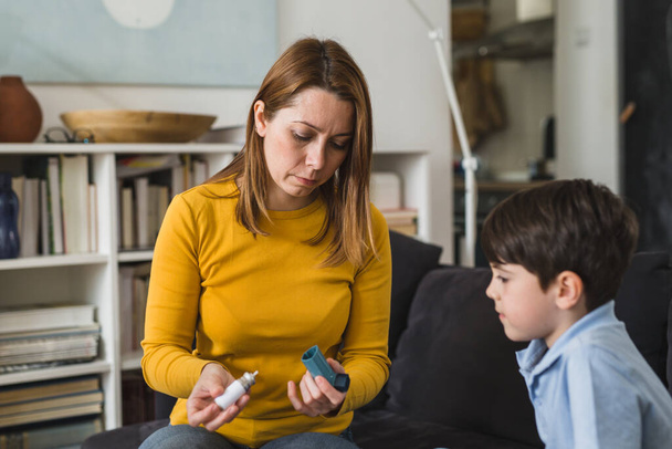 mother explains to her son how to use asthma pump - Photo, Image