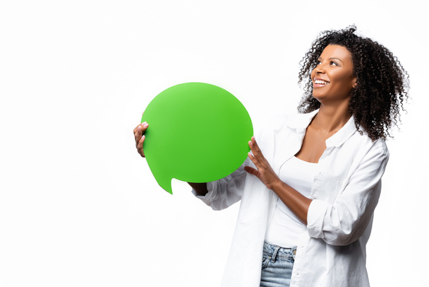 Smiling african american woman with speech bubble looking up isolated on white  - Photo, Image