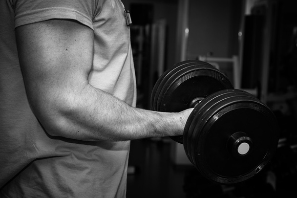 Man doing workout with heavy dumbbell - Foto, imagen